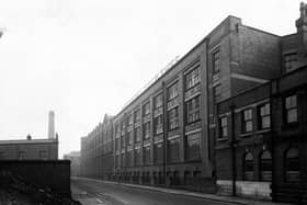 Looking north-east along Springwell Street from the junction with Holbeck Lane in February 1945. Maenson House Clothing Works, owned by Joseph May and Sons Leeds Ltd., occupies most of the length of the right-hand side. The premises are also occupied by Tom Dixon, corn dealer.