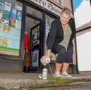 Shop worker Tracey Way, 61, pours Inch's Cider down the drain.