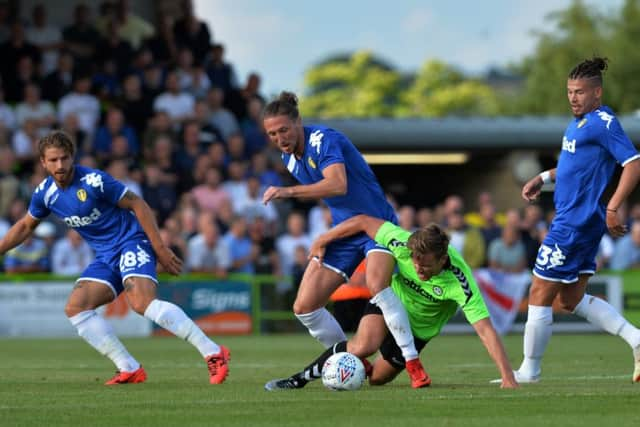 Gaetano Berardi, 
Luke Ayling and Kalvin Phillips challenge Forest Green's Dayle Grub for the ball.