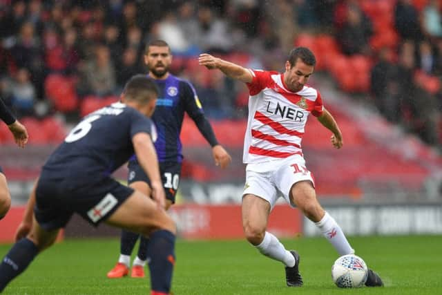 Doncaster Rovers' Matty Blair scores his team's opening goal. Picture: Dave Howarth/PA