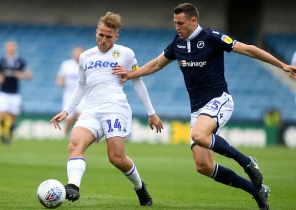 Samuel Saiz, of Leeds United and Murray Wallace, of Millwall challenge for the ball.