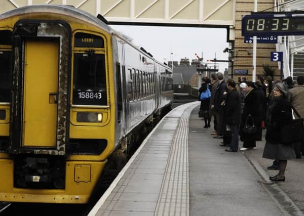 Commuters wait to board the train to Leeds at Harrogate Train Station. GS2102081c.