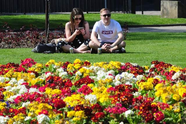 People enjoy the warm weather in Park Square, Leeds..20th April 2019.Picture by Simon Hulme