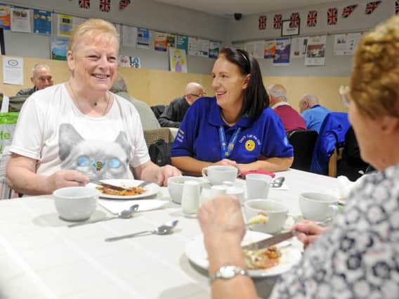 Dawn Newsome, chief executive at Armley Helping Hands, right, chats with Maureen Whelan at one of their ongoing activities - a supper club event, to combat social isolation for dozens of older people.