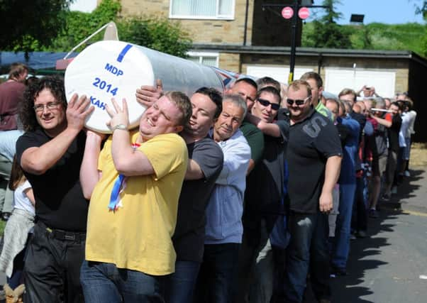 Residents carry the maypole into position in Barwick-In-Elmet. Picture: James Hardisty (JH100378a).