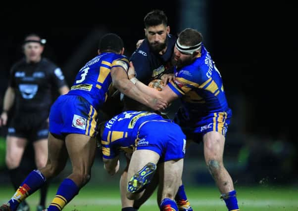 James Tamou is tackled by Leeds Rhinos Brad Singleton, Jimmy Keinhorst and Kallum Watkins during the World Club Challenge.