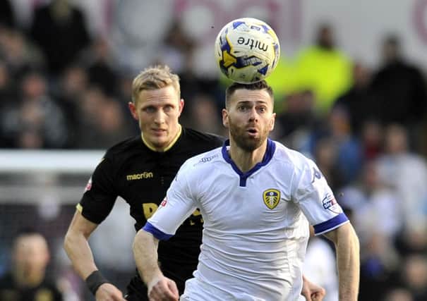 Dean Moxey and Mirco Antenucci chase the ball.