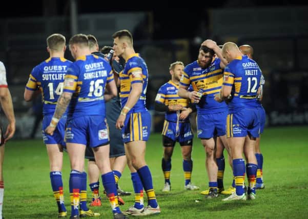 Leeds Rhinos players show their disappointment at the end of their defeat to Hull KR. Picture: Steve Riding.