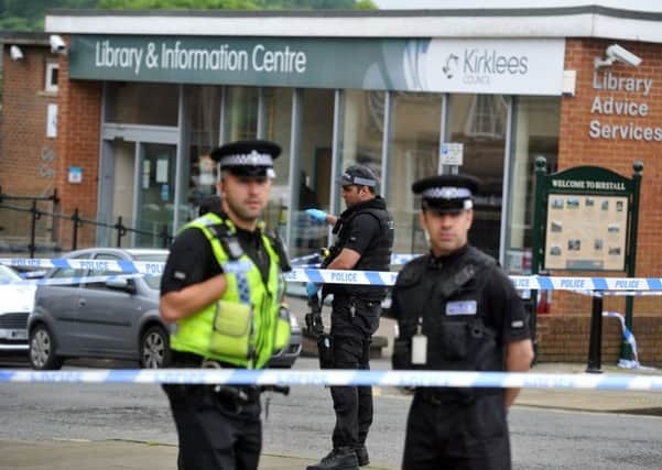 Armed police at the scene outside Birstall Library. Pictures: Tony Johnson.