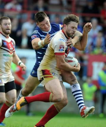 Brad Tagg of Featherstone tackles Pat Walker of Batley