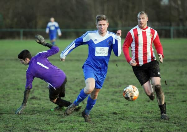 Dale Wright takes the ball past Old Centralians goalkeeper Joe Royce to score the fourth goal for Hartshead.