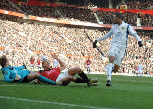 Jermaine Beckford slides the ball past Manchester United goalkeeper Tomasz Kuszczak and Wes Brown to score Leeds United's winning goal.