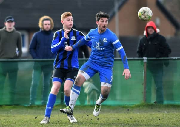 Harry Pickup, of Kippax, challenges HT Sports' Sam Ackroyd. PIC: Jonathan Gawthorpe