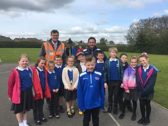 Harrison with dad, Darren, Headteacher, Andrew Symonds and Harrison's classmates from Richard Taylor.